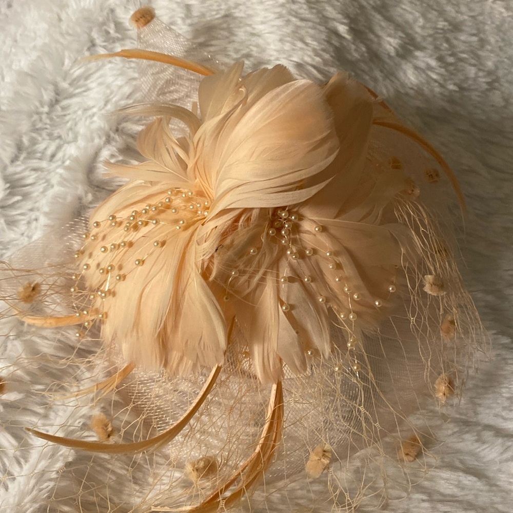 Delicate champagne/peach color fascinator by Something Special